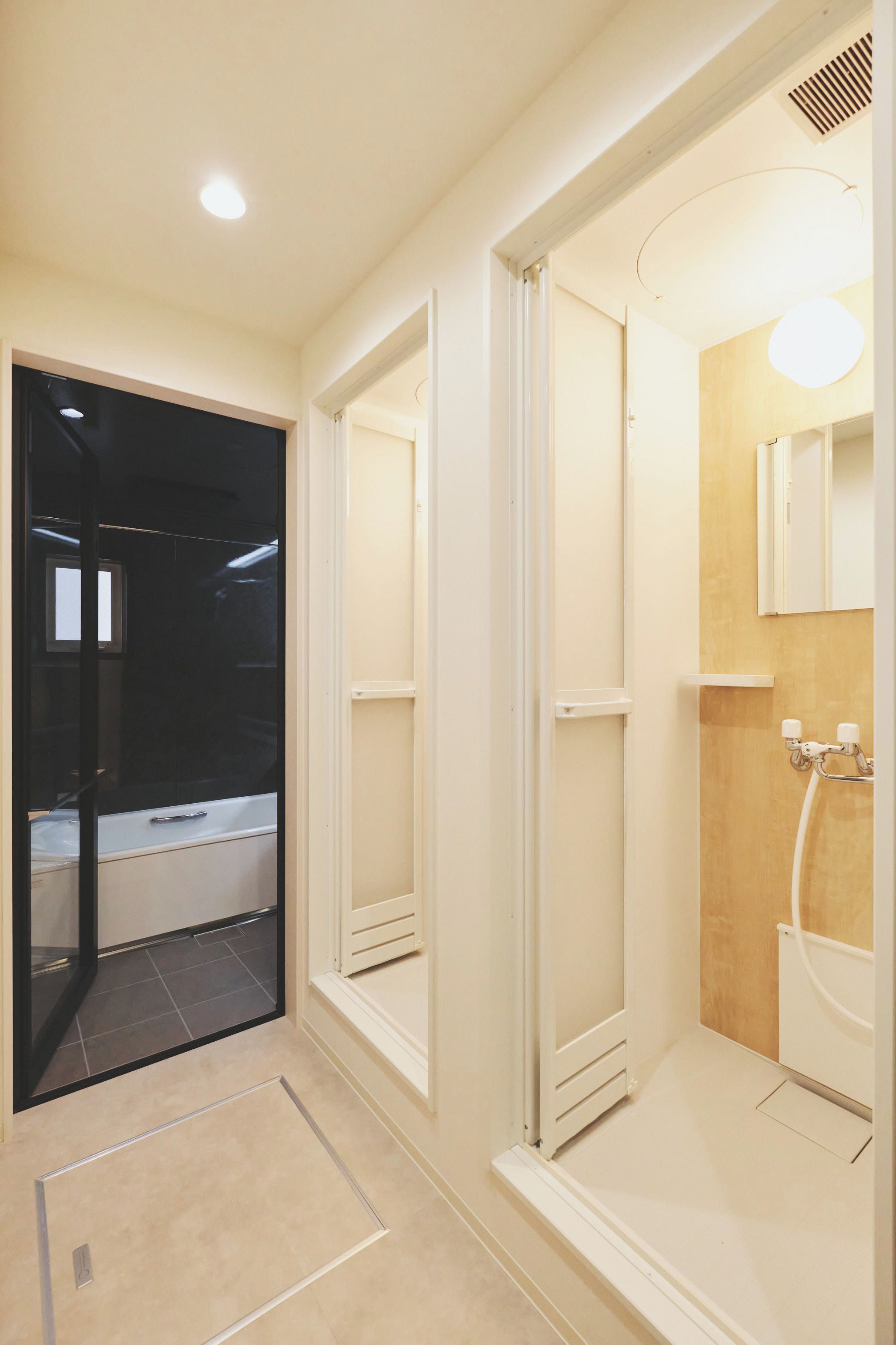 A modern bathroom with a glass shower enclosure, a bathtub, and a toilet.