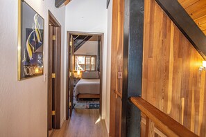 A hallway with a bed, a nightstand, and a lamp. - Ludwig's Lodge: 5 Bedroom, 3 bathroom Dollar Point home. (Tahoe City)
