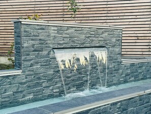 A stone wall with a water feature. - Amazing guest house for a romantic get away (Edinburgh)