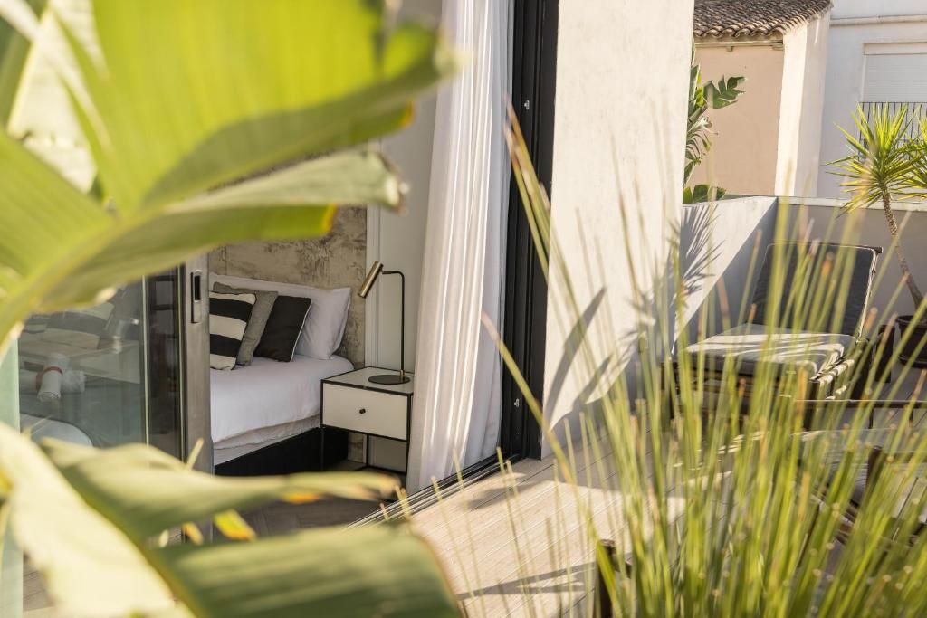 Un dormitorio moderno con cama, mesita de noche y vistas al exterior.