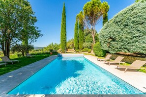 A rectangular swimming pool with a clear blue water surface, surrounded by a paved deck. - Villa Les Vignes - Four Bedroom Villa, Sleeps 10 (Joucas)