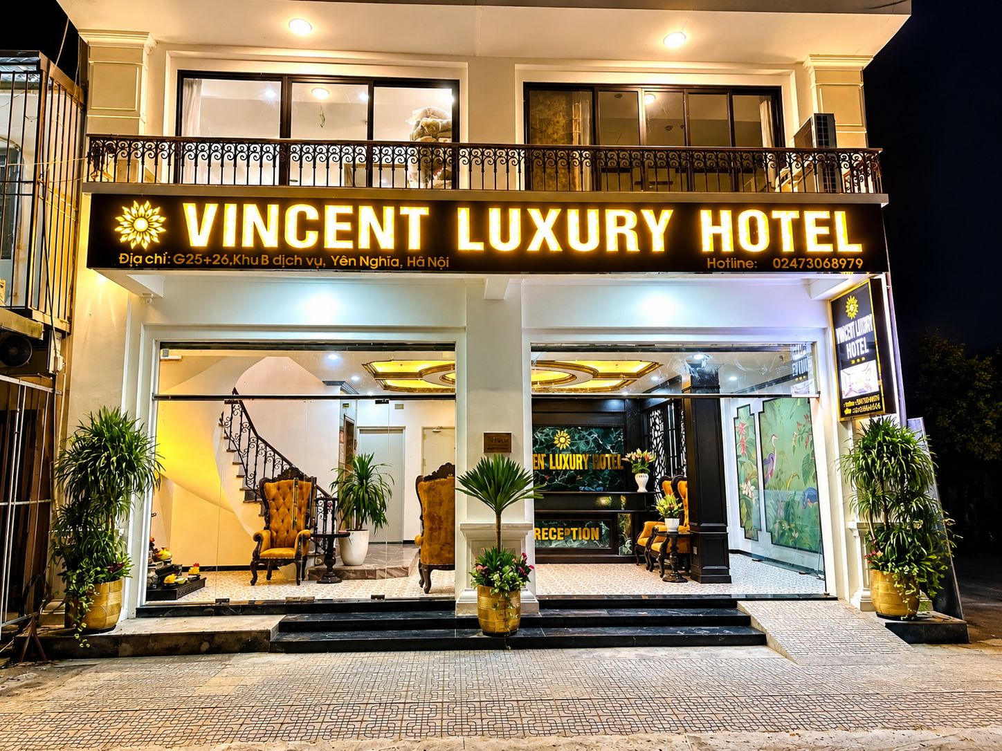 The exterior of Vincent Luxury Hotel with a reception area visible inside.