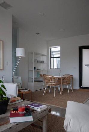 A modern living room with a dining area, white furniture, and a large window. - 301-Tropical Refuge Near Wynwood+Rubell Museum (Miami)