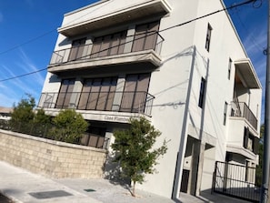 Um edifício moderno de dois andares, com sacadas e uma placa com o nome 'Casa Flambo'.