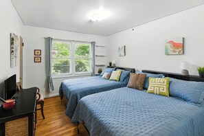 A bedroom with two beds, a desk, and a window with curtains. - Charming Ranch, 2BR Oasis Downtown Travelers Rest (Travelers Rest)