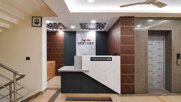 A reception desk with a sign reading 'Townhouse Oak' and a 'Say hi' sign above it.