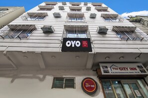 A building with multiple windows, a prominent 'OYO Hotel The City Inn' sign, and a smaller sign for 'The City Inn' with an address. - Hotel O CITY INN (Kolkata)