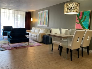 A modern living room with a sofa, chairs, a dining table, and a lamp. - Updated Old Town 1st Fl Parking Pool Spa Hot Tub (Scottsdale)