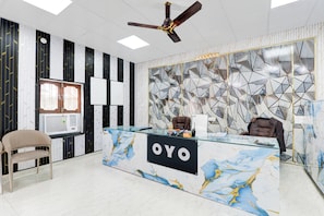 A reception desk with a marble design and the word 'YO' on it. - Hotel O Mansa Lawn & Banquets (Lucknow)