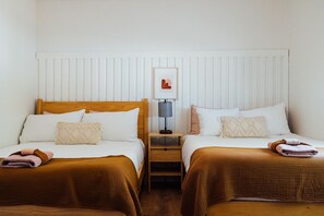 A hotel room with two beds, a nightstand, a lamp, and a framed picture on the wall. - Hot tub I Fire pit I 10 min to park I 5 min to JT (Joshua Tree)