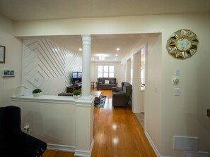 A modern living room with a fireplace, a dining area, and a kitchen visible through an open doorway. - 3-bedroom DUPLEX apartment in a serene environment Brampton, Canada (Brampton)