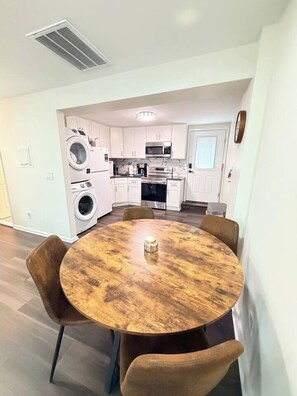 A modern kitchen with white cabinets, a built-in oven, and a washing machine. - Cozy Coastal 2 BDR Condo w/Parking Wildwood Crest (Wildwood Crest)