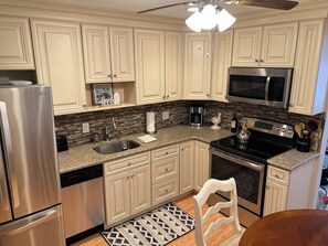 A kitchen with a stainless steel refrigerator, a microwave, a stove, and a dishwasher. - Cozy Brigantine Beach Getaway – 2 Bedrooms, 1 Block from the Beach (Brigantine)
