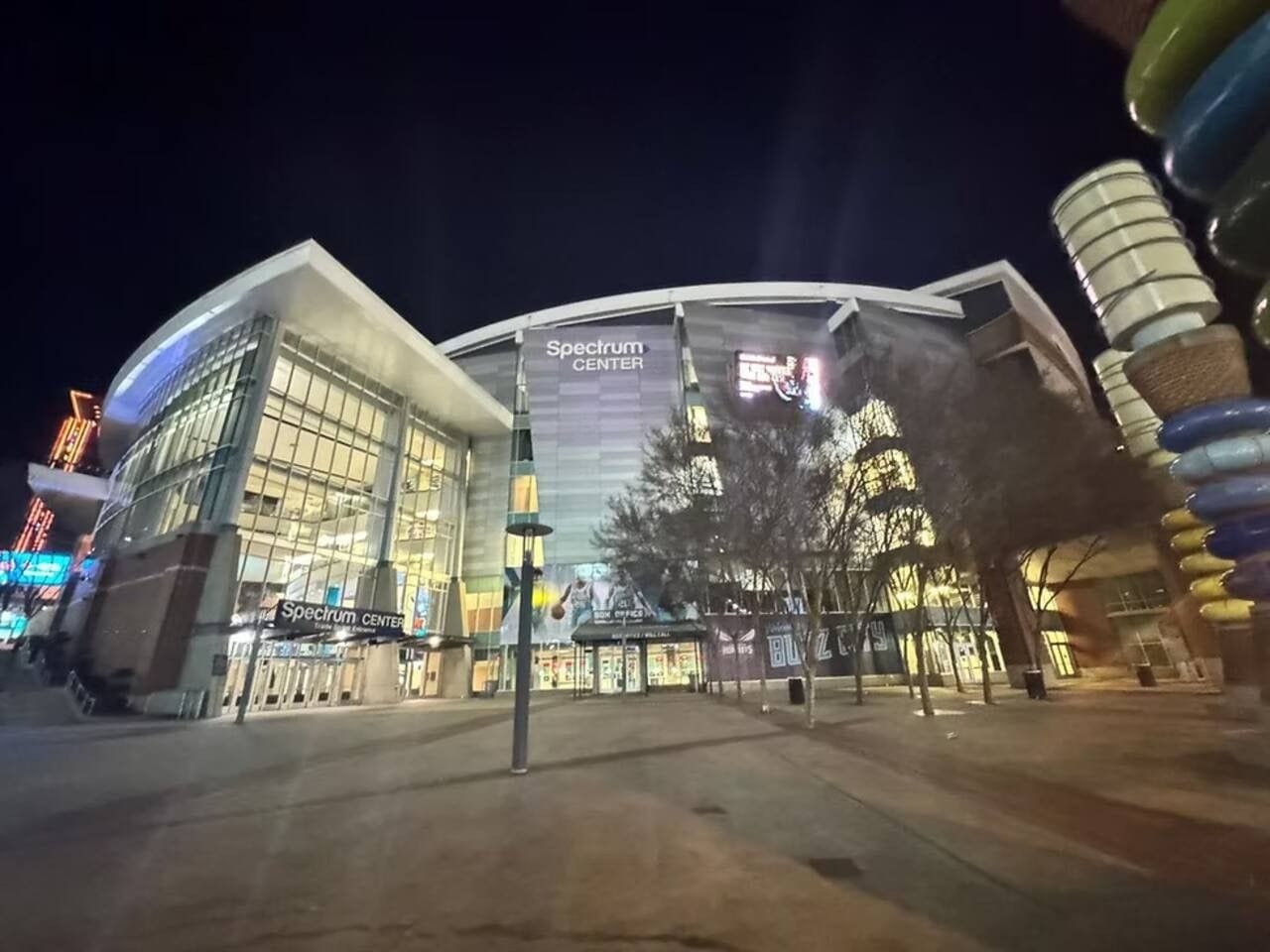 A modern building with a large glass facade and signage reading 'Spectrum Center.'