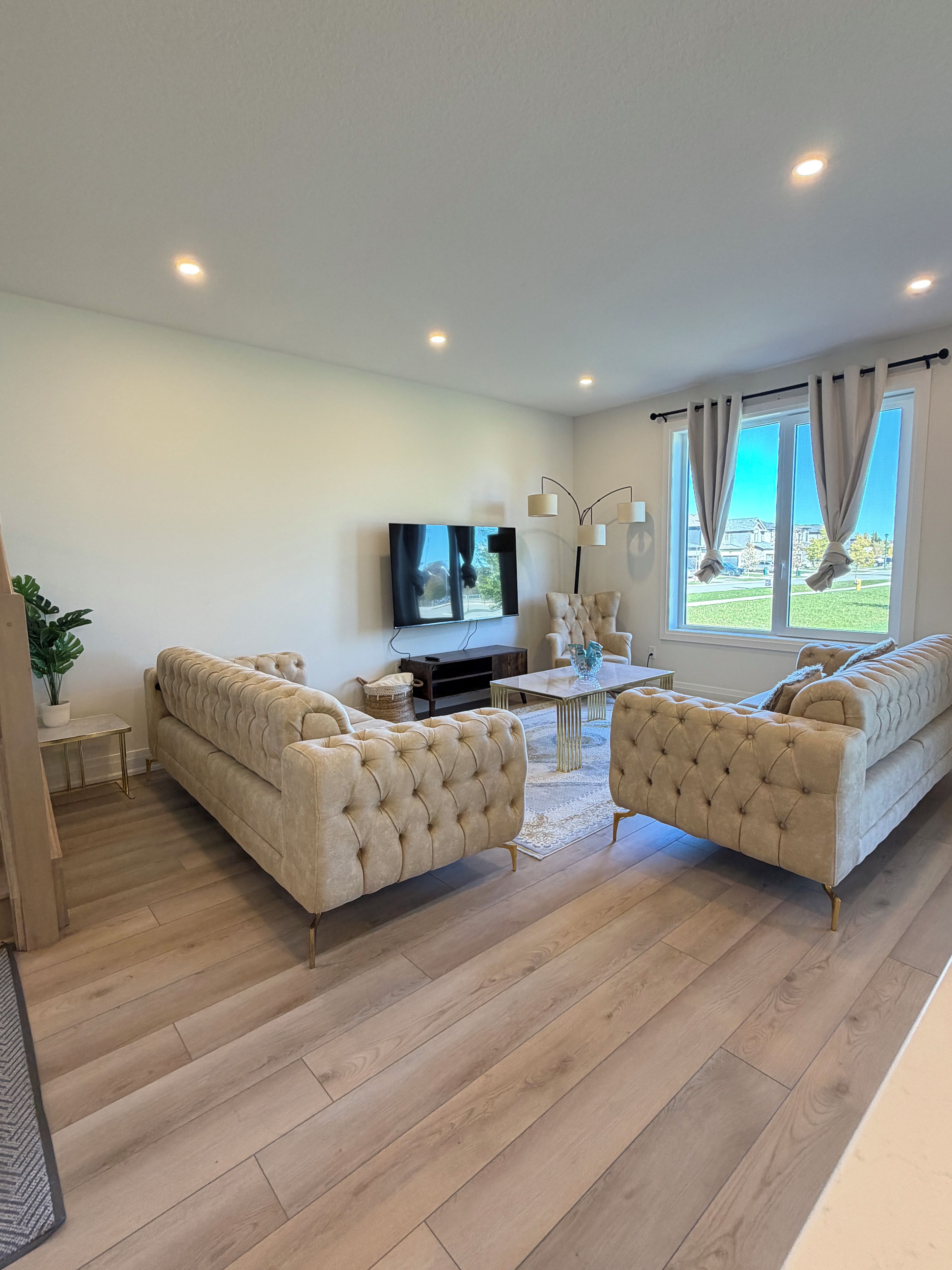 Un salon avec un canapé, une table basse et un téléviseur.