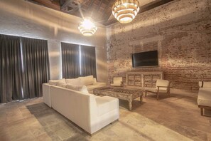 Ein Wohnzimmer mit einem weißen Sofa, einem Couchtisch und einem Kamin.