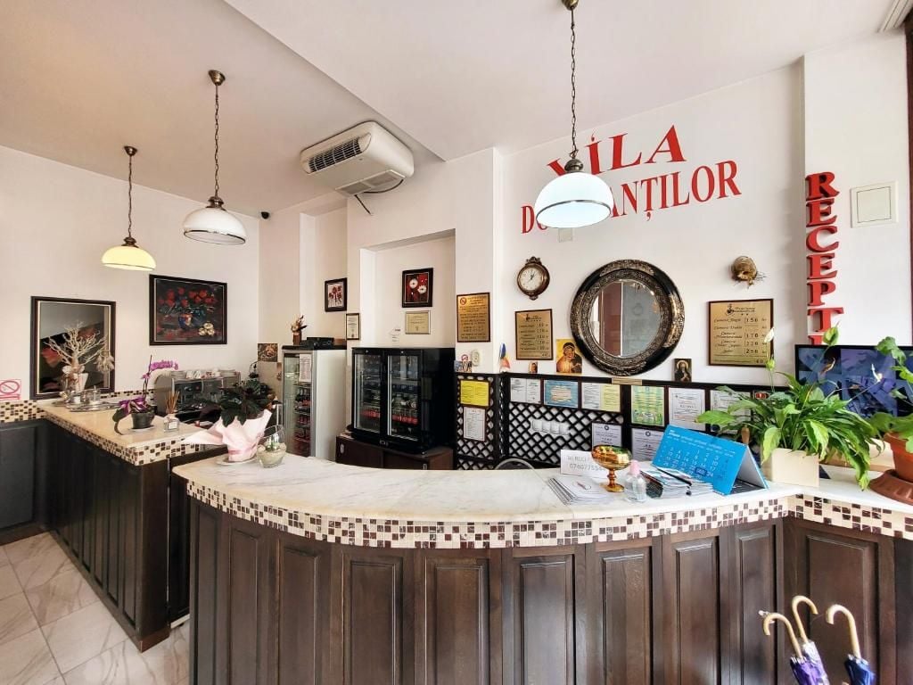 A reception area with a counter, framed certificates, and a wall clock.