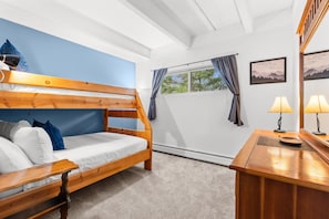 A bunk bed with a desk and lamp, a window with curtains, and a wall with a framed picture. - Tmc304f2 (Frisco)