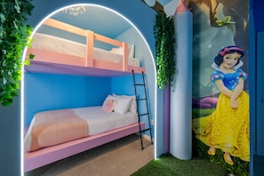 A bunk bed with a ladder, a wall mural of a character, and green foliage. - 8BR Themed Villa Pool, Game Room & Theater (Orlando)