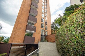 A multi-story building with a sign reading 'LA FRONTERA' and a staircase leading to the entrance. - 810 Spectacular View, Balcony and Parking (Medellín)
