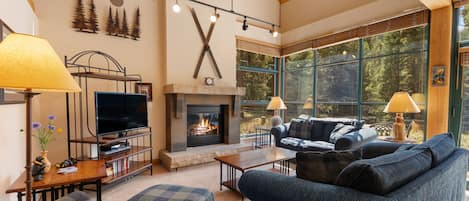 A cozy living room with a fireplace, a television, and a comfortable seating area.