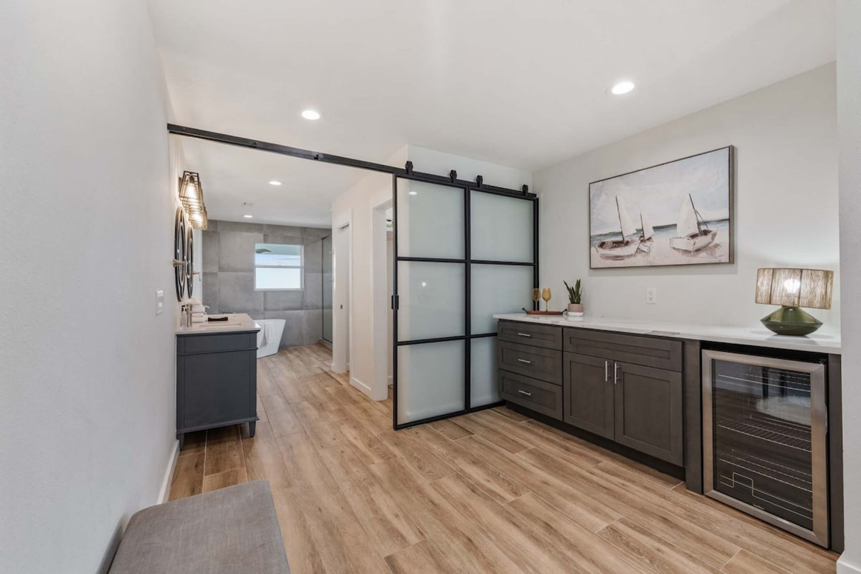 A modern kitchen with a sliding glass door leading to a bathroom.
