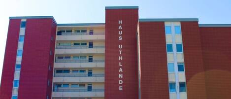 A multi-story building with a prominent vertical sign reading 'HAUS UTHLANDE'.