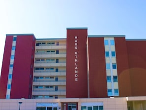 A multi-story building with a prominent vertical sign reading 'HAUS UTHLANDE'. - Uthlande Holiday Apartment 14 (Wyk auf Foehr)