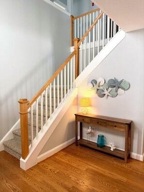 A wooden staircase with white railings leading to a landing. - Beautiful 4 bedroom home on the bike trail and east of Rt 1! (Lewes)