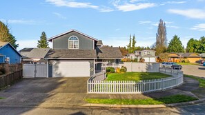 A residential property with a garage, a fenced yard, and a driveway. - Spacious 4BD home with hot tub, game room, fully fenced large corner lot. (Monroe)