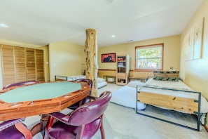 A room with a pool table, a bed, a dresser, and a window. - Mountain Views - Hot Tub Two Game Rooms (Monument)