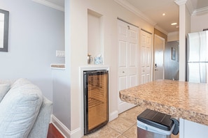 A kitchen with a granite countertop, a dishwasher, and a trash bin. - Bayview 2BR Condo Close to Beach (Ocean City)