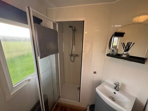 Bright bathroom with walk-in shower and plenty of natural light