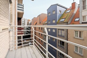 A multi-story residential building with balconies, a visible stairwell, and a clear sky. - 2 bedroom accommodation in Nieuwpoort (Nieuwpoort)