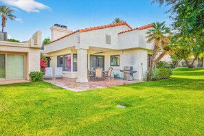 A residential house with a patio, outdoor seating, and a well-maintained lawn. - 3-Bedroom Desert Oasis Just Steps to La Quinta Resort! (La Quinta)