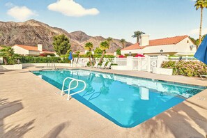 A swimming pool with lounge chairs and a view of mountains. - 3-Bedroom Desert Oasis Just Steps to La Quinta Resort! (La Quinta)