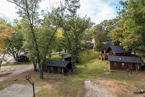 A campground with rustic cabins, a basketball court, and a picnic area. - Cozy Corner at Sommer Dorf (West Branch)