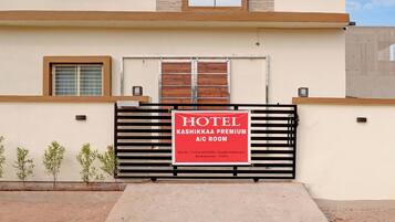 A hotel entrance with a gated A/C room.