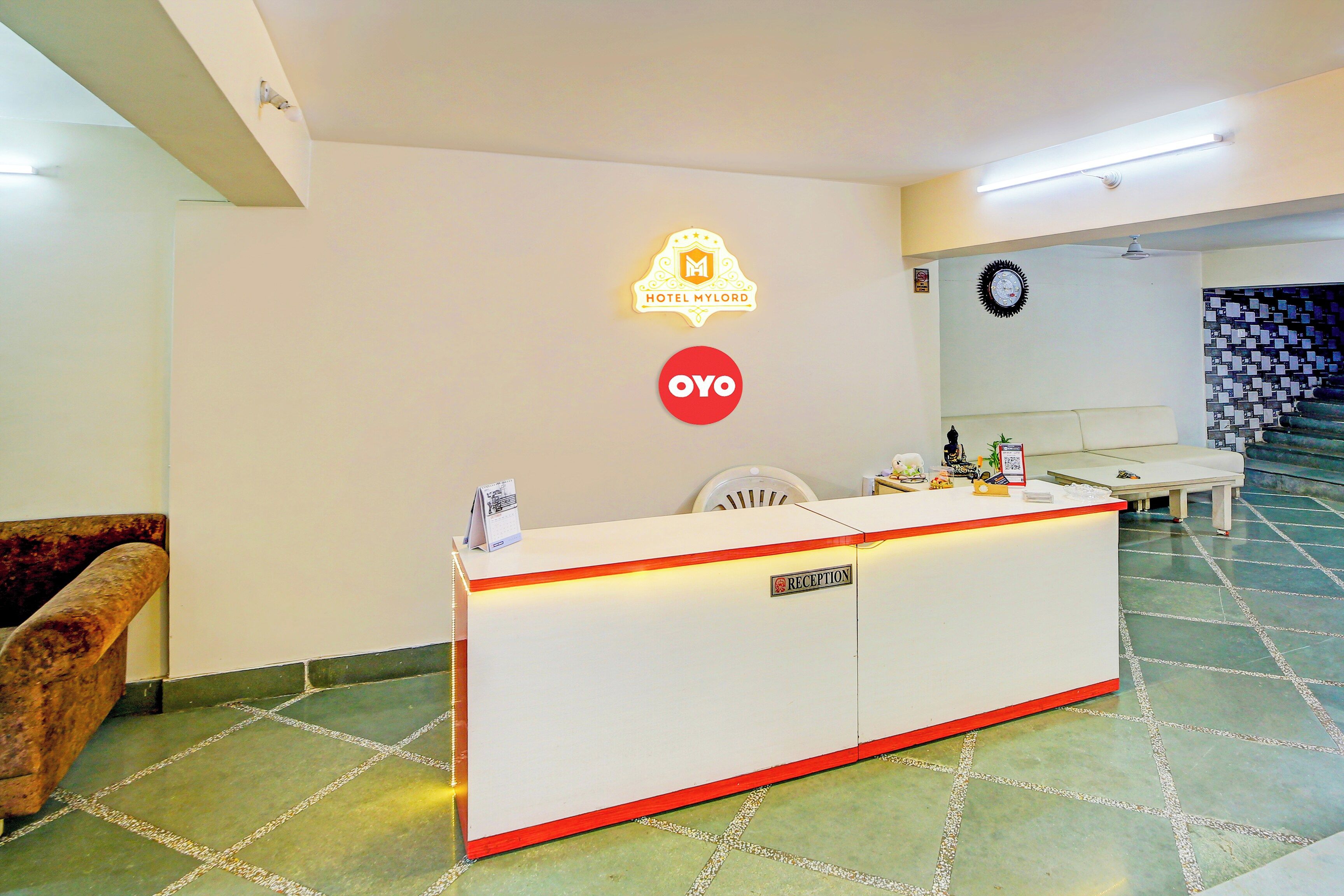 A hotel reception desk with a 'HOTEL MY LORD' sign, a 'YOYO' logo, and a 'RECEPTION' sign.
