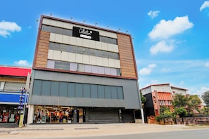 A multi-story building with a sign reading 'Collection Company-Serviced'.