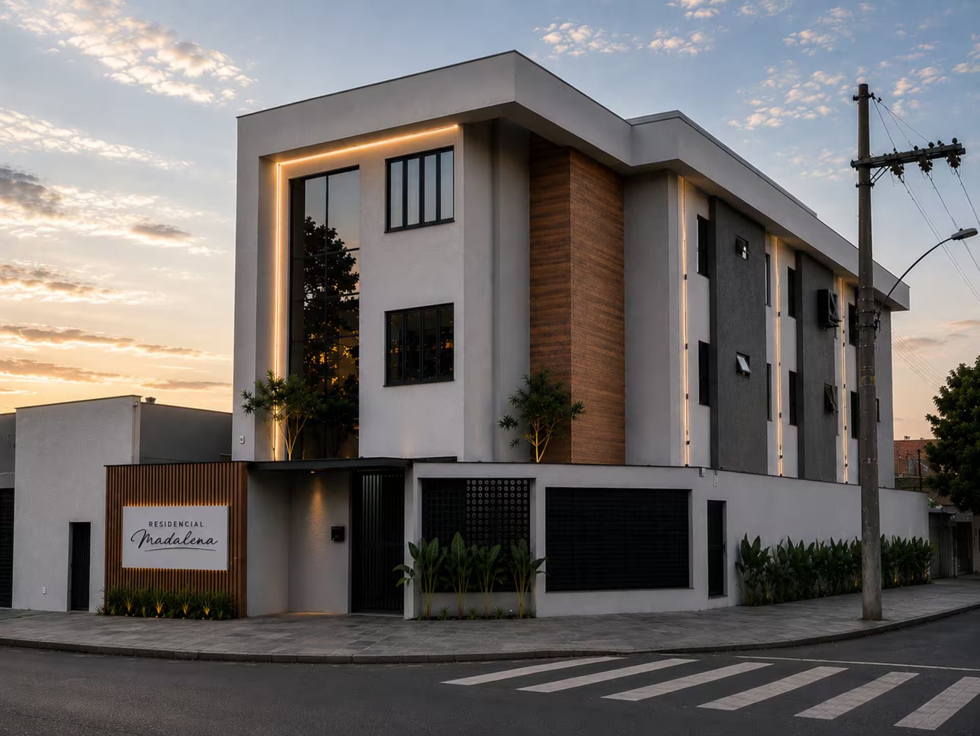 A modern two-story building with a flat roof, large windows, and a sign indicating it is a residential property.