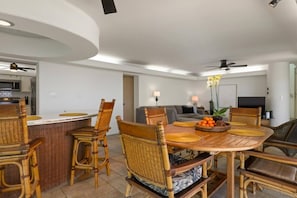 A modern living space with a dining area, kitchen, and seating area. - Sunsets on the Shoreline | Oceanfront Kona Home (Kailua-Kona)