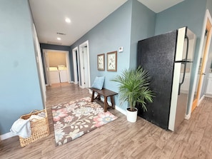A modern kitchen with a refrigerator, a bench, and a potted plant. - Charming 10 acre homestead stay in Ennis (Ennis)