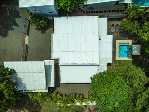 An aerial view of a property with a swimming pool, a covered patio area, and surrounding greenery. - Private Pool Villa • Gated • Near Playa Negra (Provincia de Guanacaste)