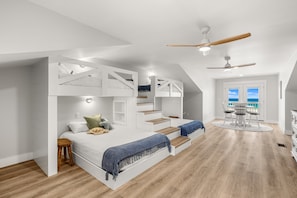 Une chambre moderne avec un lit superposé, un bureau et une table à manger.