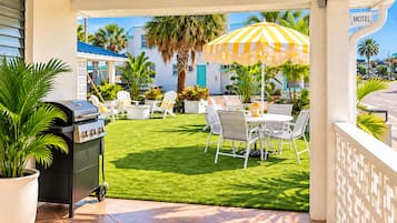 A patio with a grill, outdoor seating, and a 'Motel' sign.