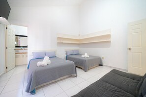 A room with two beds, a sofa, a bathroom, and a small kitchen area. - Private Villa Pool and Tennis Court 7BR (Cancún)