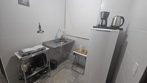 A compact kitchenette with a sink, a small countertop, and a refrigerator. - New Listing (João Pessoa)