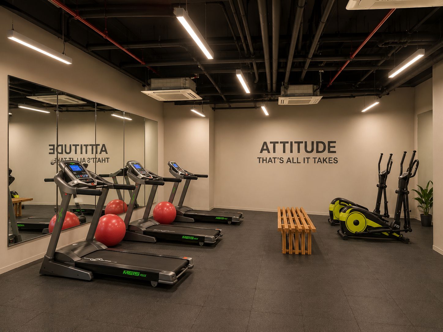 Ein Fitnessraum mit Laufbändern, Übungsbällen und einer Wand mit motivierenden Texten.