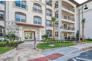 A multi-story residential building with a flat facade, balconies, and a gated entrance. - Your Orlando Retreat, 3BR at Prime Location (Orlando)